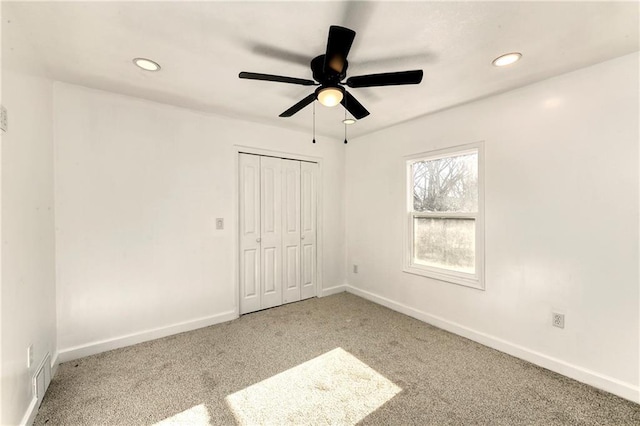 unfurnished bedroom with carpet floors, ceiling fan, and a closet