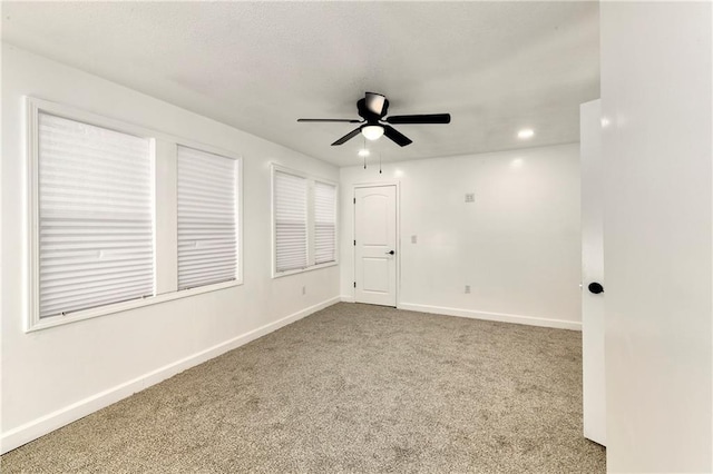 empty room featuring carpet floors and ceiling fan