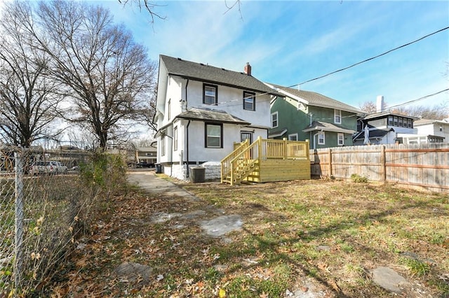 rear view of property with central AC unit