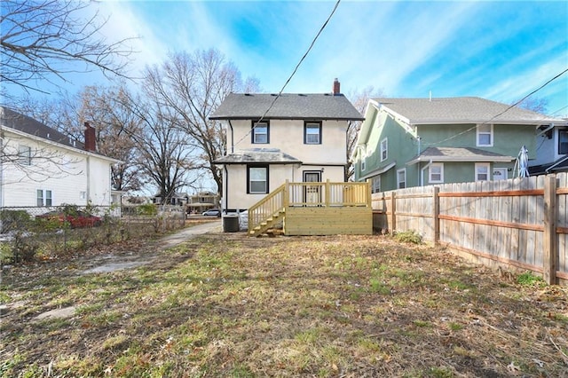 back of house featuring central AC unit and a wooden deck