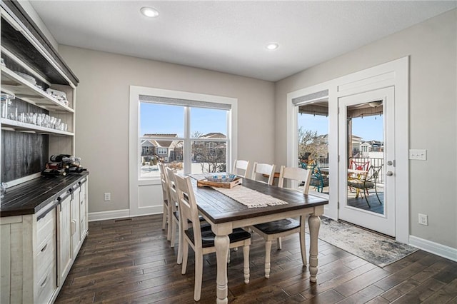 dining space with dark hardwood / wood-style floors