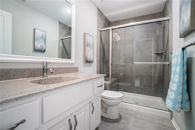 bathroom with toilet, vanity, tile patterned flooring, and an enclosed shower