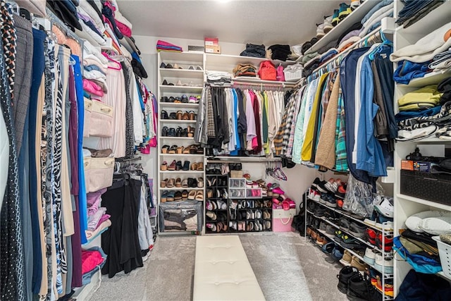 spacious closet with carpet