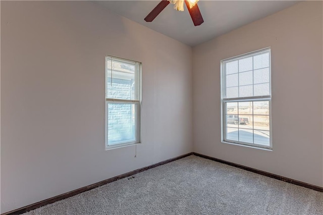 carpeted empty room featuring ceiling fan