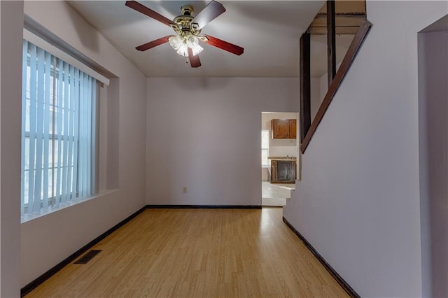 unfurnished room featuring ceiling fan and light hardwood / wood-style floors