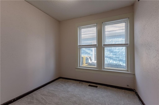 unfurnished room with light colored carpet