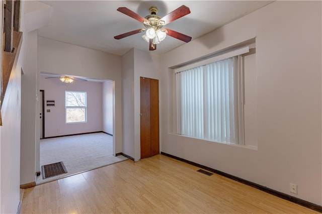 empty room featuring ceiling fan and light hardwood / wood-style flooring