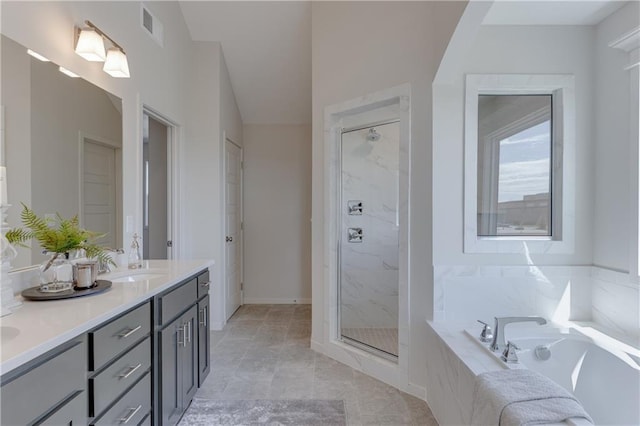 bathroom featuring vanity and shower with separate bathtub