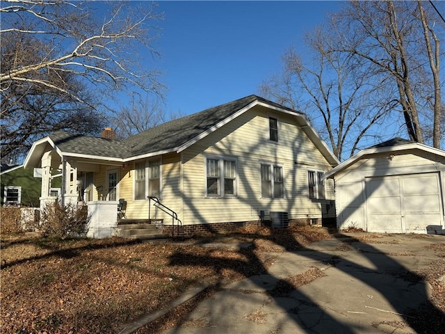 view of home's exterior featuring an outbuilding, cooling unit, and a garage