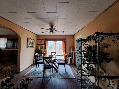 dining area featuring ceiling fan, dark hardwood / wood-style flooring, and ornamental molding