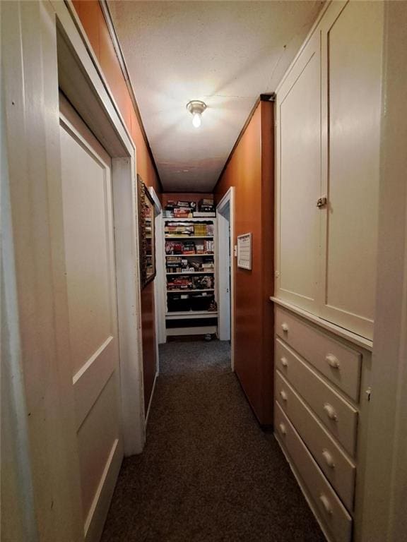 hallway with dark colored carpet