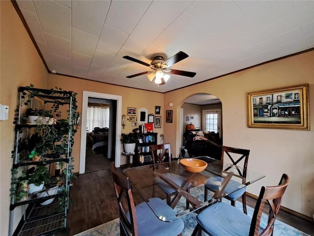 dining space featuring ceiling fan, dark hardwood / wood-style flooring, and ornamental molding