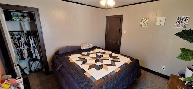 carpeted bedroom featuring crown molding and a closet