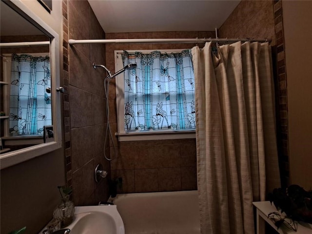 bathroom with sink and shower / tub combo with curtain