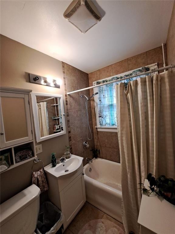 full bathroom featuring toilet, vanity, tile patterned floors, and shower / bath combo with shower curtain