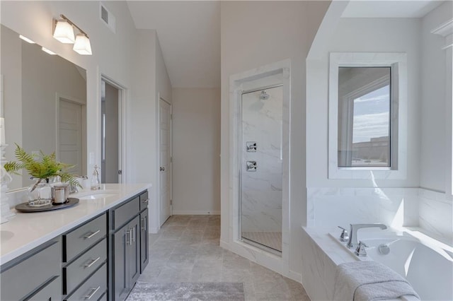 bathroom featuring vanity and separate shower and tub