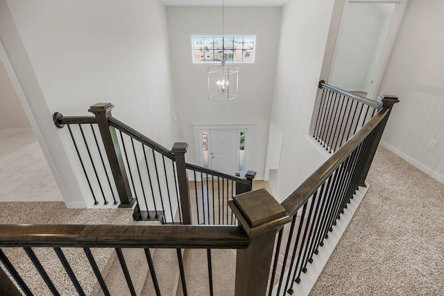 17157 W 164th Ter, Olathe, KS 66062 - stairs featuring a chandelier, carpet floors, and marble look tile flooring