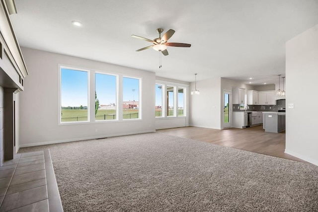 17157 W 164th Ter, Olathe, KS 66062 - unfurnished living room with light colored carpet, a ceiling fan, and recessed lighting