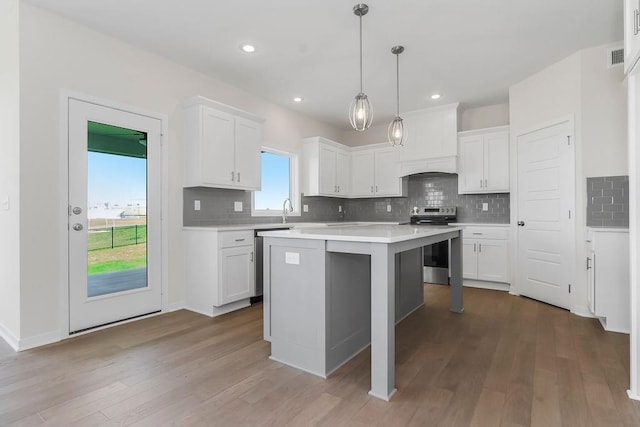 17157 W 164th Ter, Olathe, KS 66062 - kitchen featuring appliances with stainless steel finishes, light countertops, white cabinetry, decorative backsplash, and recessed lighting