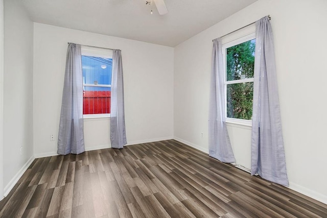 unfurnished room with ceiling fan and dark hardwood / wood-style flooring