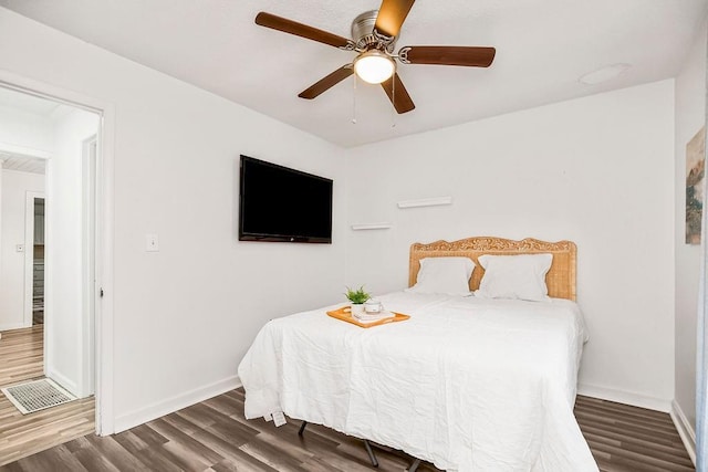 bedroom featuring ceiling fan and dark hardwood / wood-style flooring