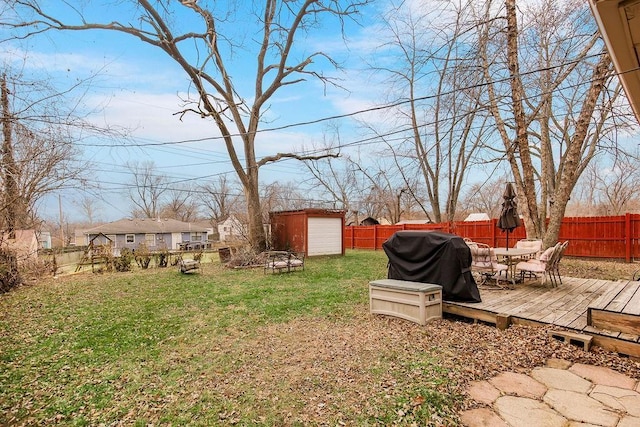 view of yard with a storage shed and a wooden deck