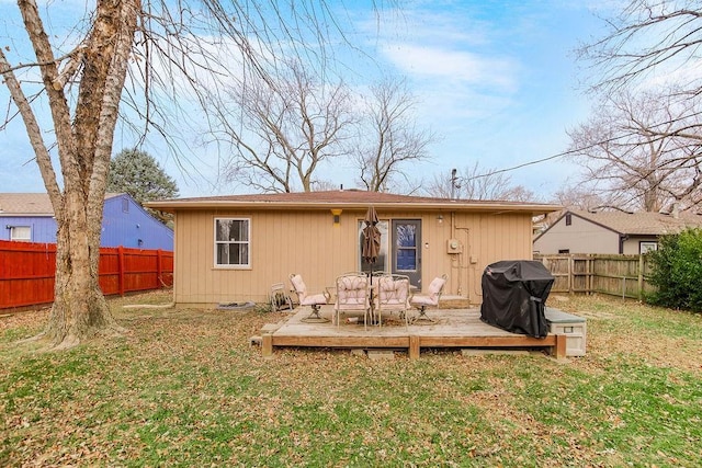 back of house featuring a yard and a wooden deck