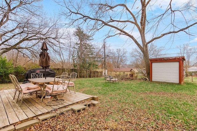 view of yard featuring an outbuilding, a garage, and a deck