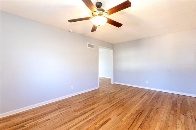 empty room with ceiling fan and light hardwood / wood-style floors