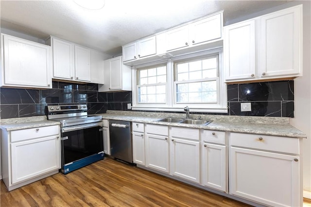 kitchen featuring white cabinets, dishwasher, electric range oven, and sink