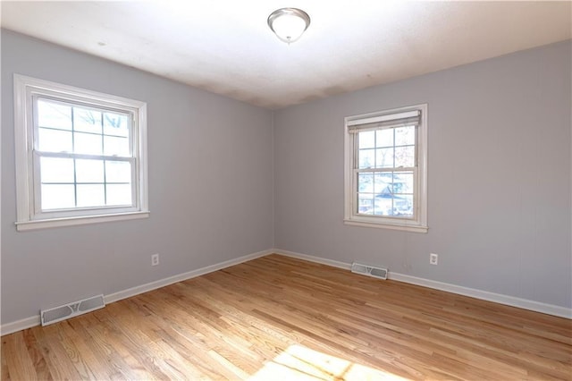 unfurnished room featuring light hardwood / wood-style flooring and a healthy amount of sunlight