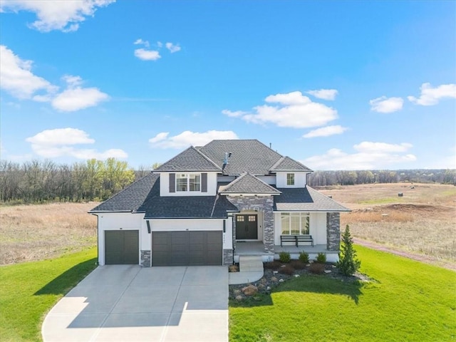 view of front facade featuring stone siding, concrete driveway, and a front lawn