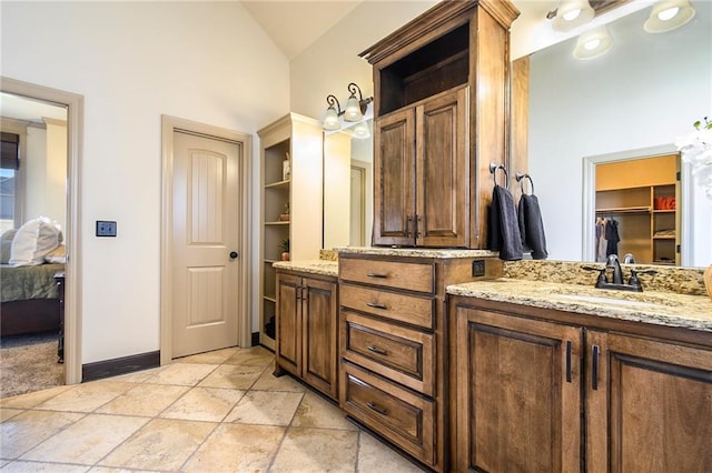 bathroom featuring vanity and vaulted ceiling