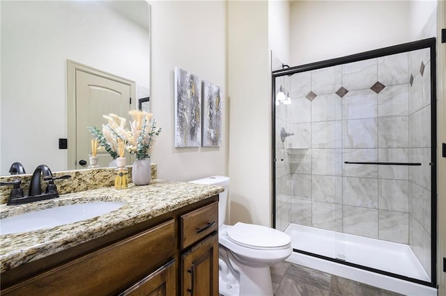 bathroom featuring vanity, walk in shower, and toilet