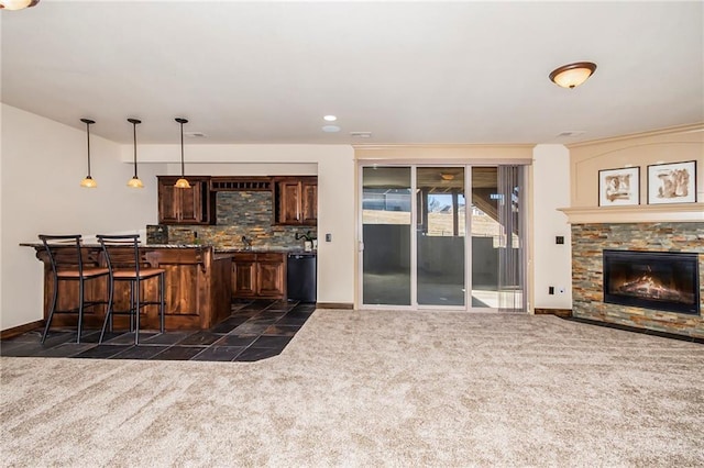 bar featuring dark colored carpet, black dishwasher, pendant lighting, and backsplash