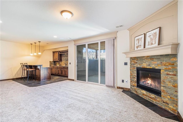 carpeted living room featuring a fireplace