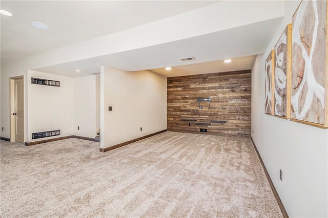 basement with carpet floors and wood walls