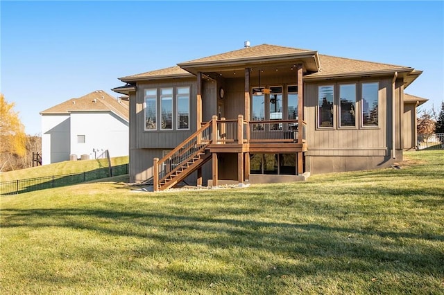 back of property featuring a deck and a lawn