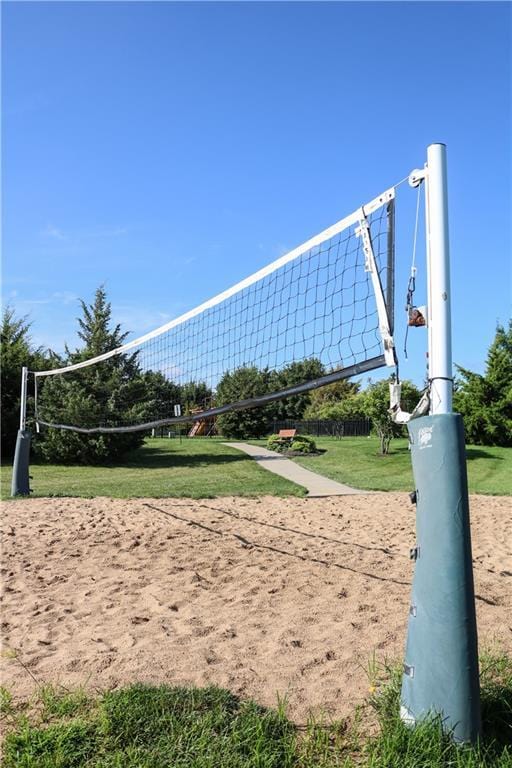 view of community with a lawn and volleyball court