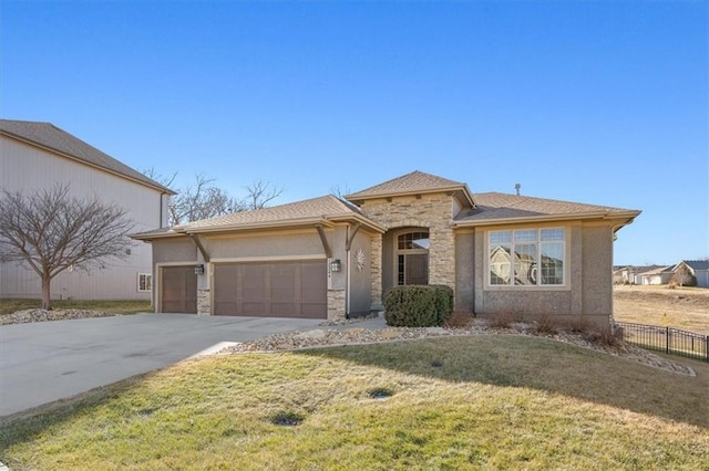 view of front facade with an attached garage, fence, stone siding, concrete driveway, and a front yard