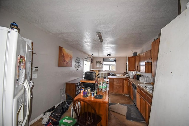 kitchen featuring white refrigerator and a textured ceiling