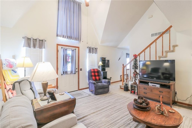 living room with high vaulted ceiling