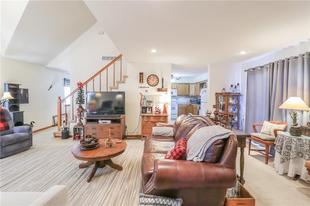 living room featuring ceiling fan and light colored carpet