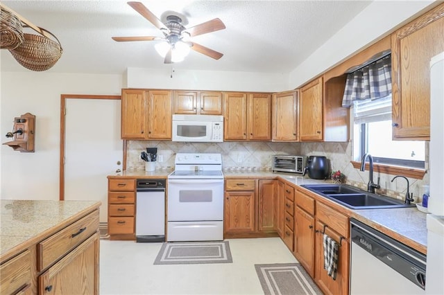 kitchen with backsplash, ceiling fan, white appliances, and sink