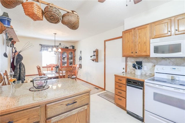 kitchen with decorative backsplash, ceiling fan with notable chandelier, decorative light fixtures, and white appliances