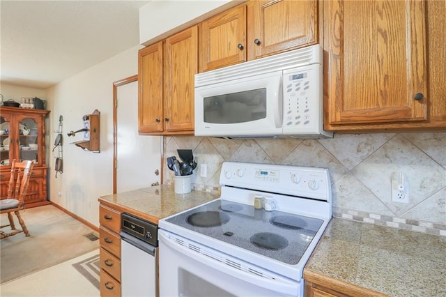 kitchen with backsplash and white appliances