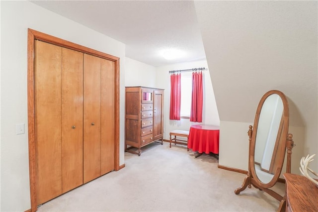 sitting room featuring light carpet