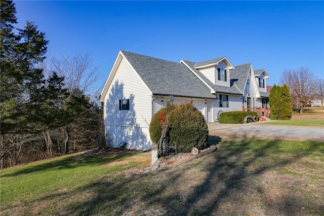 view of side of home featuring a lawn