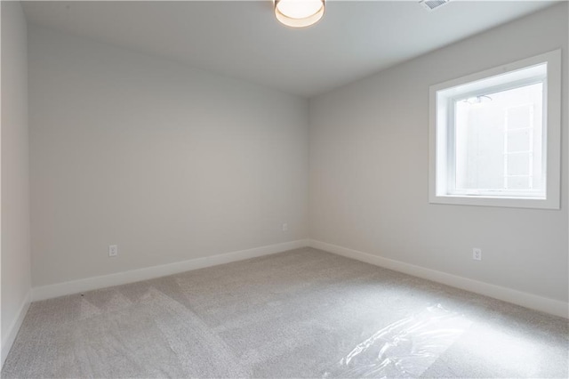 empty room featuring light colored carpet