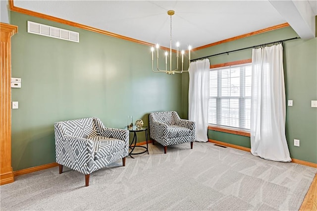 sitting room with a notable chandelier, carpet, and ornamental molding